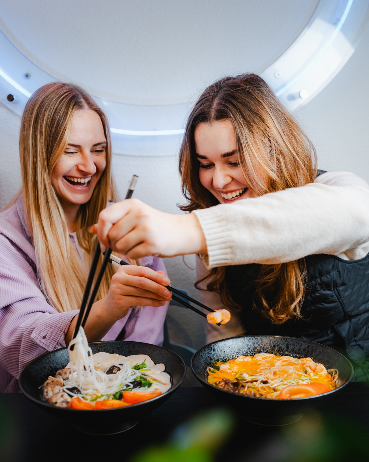 Two guests sharing pho and noodle bowls at Bonsai Liptovský Mikuláš
